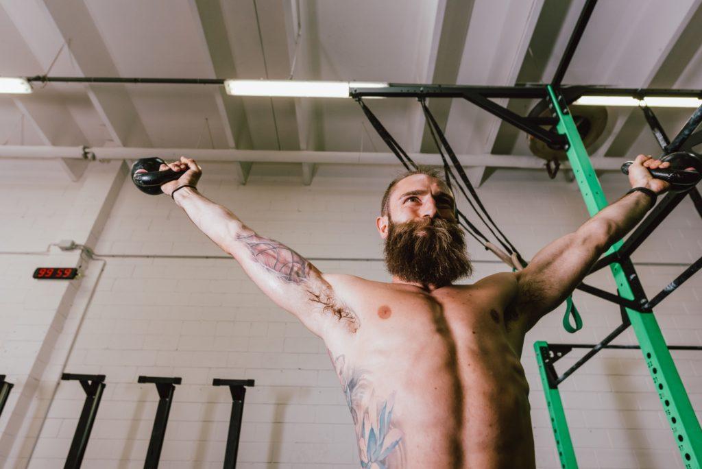 young bearded man training gym